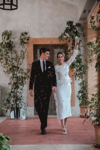 Vestido midi blanco con manga larga y pluma en cintura y falda