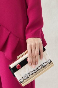 clutch de fiesta dorado con plumas blancas y negras y piedras
