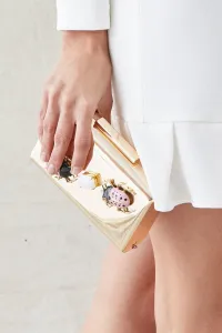 clutch de fiesta dorado con insecto joya rosa y negro y piedra